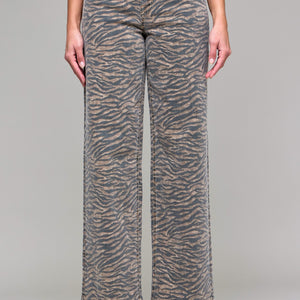 Person wearing zebra print pants on a plain background