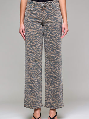 Person wearing zebra print pants on a plain background